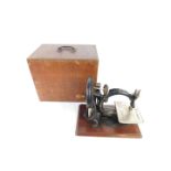A late 19thC Willcox & Gibbs sewing machine, cased.