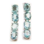 A pair of 18ct white gold and Paraiba tourmaline drop earrings, each set with four oval cut