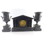 A Victorian slate mantel clock, the circular brass dial with enamel chapter ring bearing Arabic