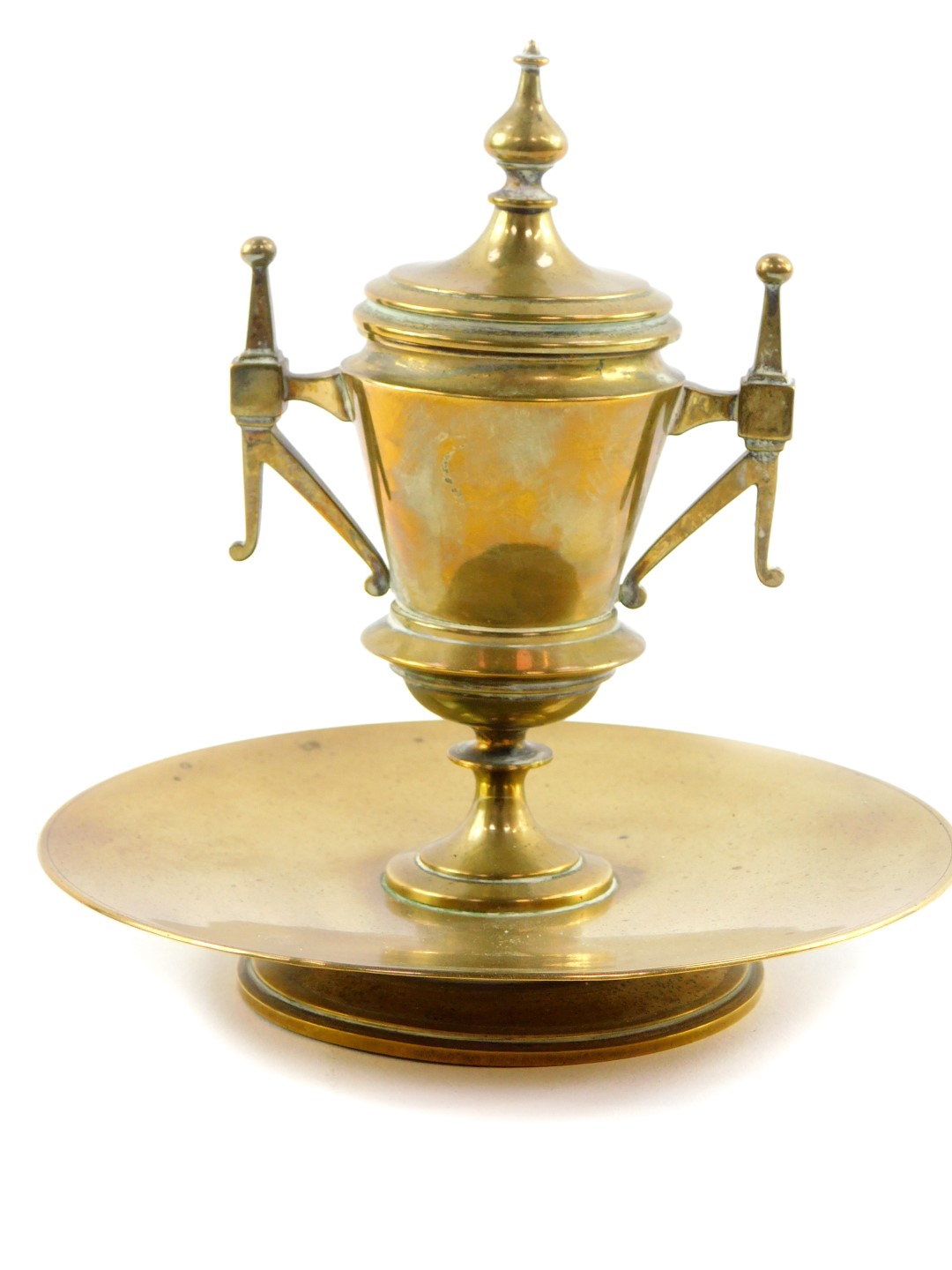 A Victorian brass ink well, of twin handled baluster vase and cover form, with ceramic liner, raised