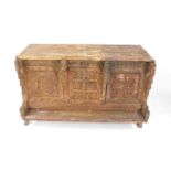 An Indian Sub-Continent rustic hardwood cupboard, the front carved with reptile buttresses, metal