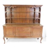 A Victorian oak dresser, the outswept pediment over a three shelf plate rack, flanked by six