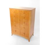 A mid 20thC satin walnut and plywood chest of drawers, having two short over four long graduated