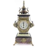 A French bi-colour marble mantel clock, the circular enamel dial bearing Roman numerals, thirty hour