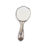 A George V silver hand mirror, with engine turned decoration, oval reserve monogram engraved, London