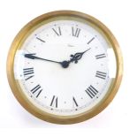 A mid 20thC Gibson brass metal coated tin circular slave wall clock, dial bearing Roman numerals,