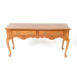 An 18thC style light mahogany and yew wood cross banded side table, with two frieze drawers and a
