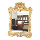 A Rococo style giltwood rectangular wall mirror, inset bevelled glass, with pierced foliate scrolls,