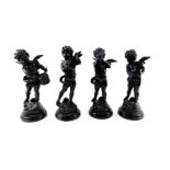 A set of four 19thC style L and F Moreau bronze figures of cherubs, modelled standing playing