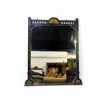 A Victorian Aesthetic Movement ebonised overmantel mirror, with a galleried top rail and demi lune