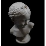 A plaster bust of a girl, with corn braids and ribbons in her hair, on a circular socle base, 34cm