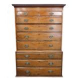 A George III mahogany chest on chest, the outswept pediment with dental moulding, over five