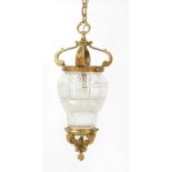 A Victorian style brass and cut glass ceiling lantern, with leaf cast scrolling arms, and