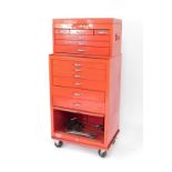 A Taskmaster red metal mechanics tool chest, of two section form, the upper section with one