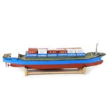 A kit built remote controlled model of a cargo ship Fairwind, blue and red body, with containers,