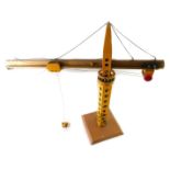 A wooden scratch built model crane, yellow painted, 80cm H.