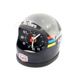A Heuer desk clock modelled as James Hunt's helmet, black with decals, battery operated.