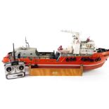 A kit built remote controlled model of a boat Aziz, red hull, with Planet digital control, 41cm H,