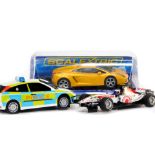 Three Scalextric model cars, comprising Lamborghini Gallardo, Honda Racing F1 car, and Ford Focus