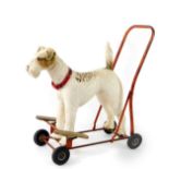 A Tri-ang push-a-long dog, the moulded plastic terrier mounted on red metal frame, 61cm H.