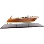 A scale model of an Italian Riva motor boat, with wooden hull and cream leather interior, on