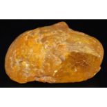 A large piece of clear amber coloured petrified tree resin, 10cm L, 197g. Upon initial inspection as