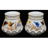 A pair of Royal Worcester blush ivory small squat vases, shape code 991, decorated with butterflies,