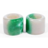 Two Chinese jade archers' rings, in green and white, each approx 4cm H. (2) Upon initial