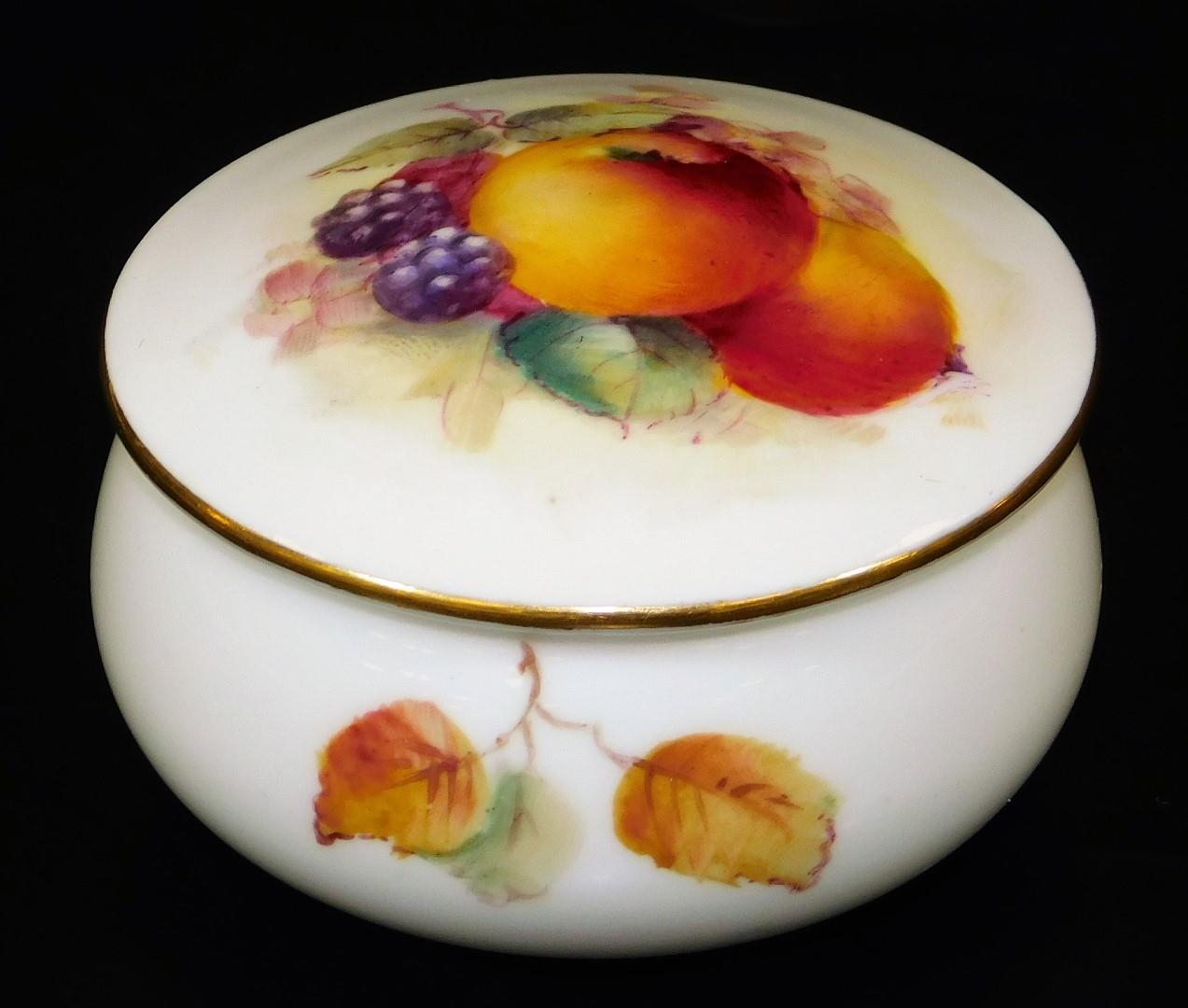 A Royal Worcester porcelain jar and cover, handpainted with autumnal fruits, blackberries and apples
