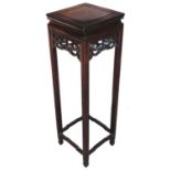 A Chinese hardwood plant stand, the square top raised above a pierced and carved scroll frieze, on
