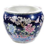 A Chinese dark blue ground porcelain fish bowl, of bulbous form, decorated with birds on flowering