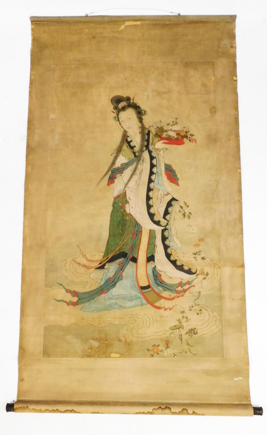 A Chinese scroll, painted with the figure of the goddess of compassion Guan Yin standing on a