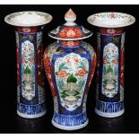 A Japaneseiece three piece Imari garniture comprising two trumpet vases and a lidded baluster jar,