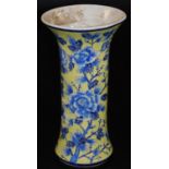 A Chinese porcelain beaker vase, decorated with flowers in blue on a yellow ground, 34cm H. There is