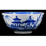 A 19thC Chinese blue and white bowl, profusely decorated with buildings, figures and tress, on a
