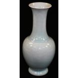 A bulbous Japanese porcelain celadon vase with trumpet neck, the body with incised panels, two