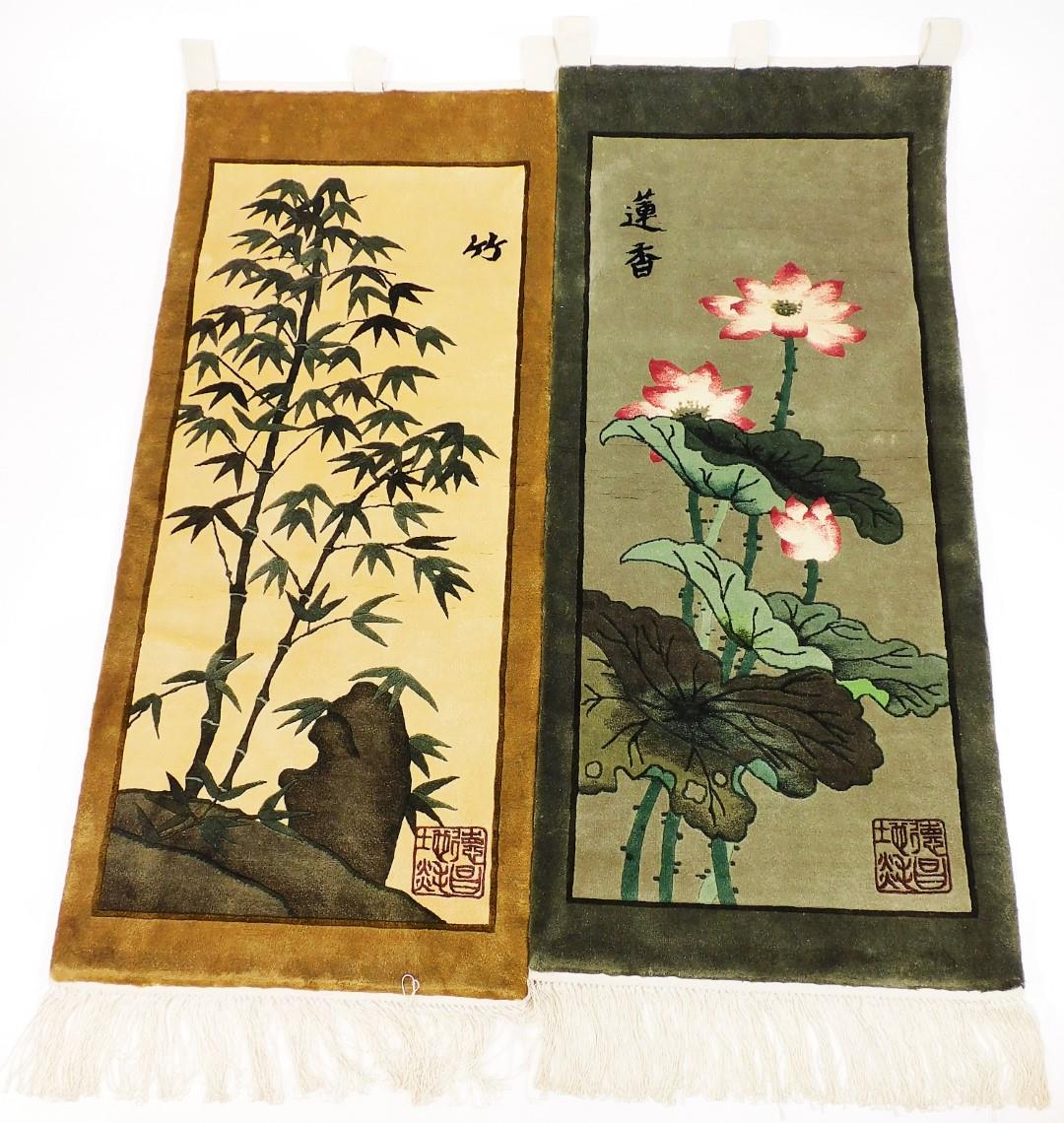 Two 20thC oriental material wall hangings, decorated with flowers, scenes and bamboo, signed with