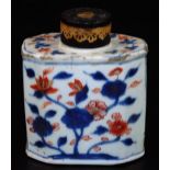 An 18thC Chinese Imari porcelain tea caddy, decorated with flowers, of octagonal form with metal