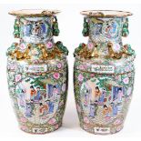 A large pair of Chinese Canton vases, each of shouldered form, decorated with panels of figures,
