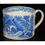 An early 19thC small pottery tankard, printed in blue and white with a thatched cottage pattern,