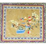 A Chinese rectangular framed silk panel, embroidered with a vase of flowers within an elaborate