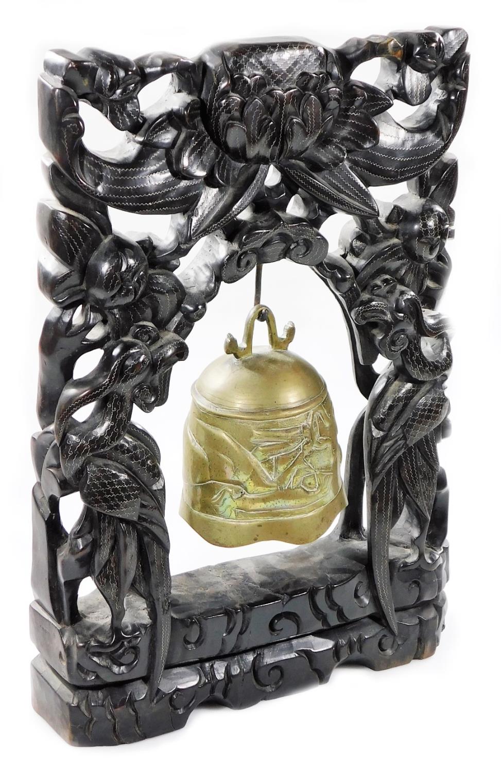 A heavily carved Chinese 19thC dinner gong, the shaped stand carved with exotic birds, pierced