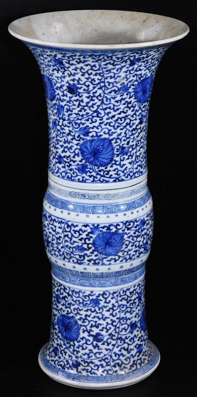 A Chinese porcelain blue and white beaker vase, with flared base and neck, decorated with