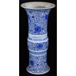 A Chinese porcelain blue and white beaker vase, with flared base and neck, decorated with