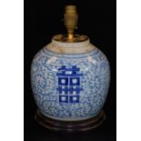 A Chinese blue and white porcelain ginger jar converted to a lamp, with scrolling lotus foliage