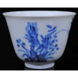 A Chinese porcelain blue and white month cup, with six character Kangxi mark, decorated with orchids