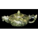 A Chinese Bowenite teapot and cover, of squat form, in mottled green tones, 12cm Dia. There is no