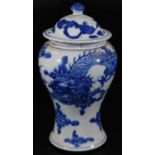An 19thC Chinese blue and white baluster vase and cover, decorated with four claw celestial