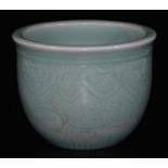 A Chinese porcelain celadon green jardiniere, of circular form with a incised twisted scroll