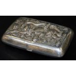 A 19thC Chinese Canton white metal repousse cigarette case, decorated with dragons and clouds around